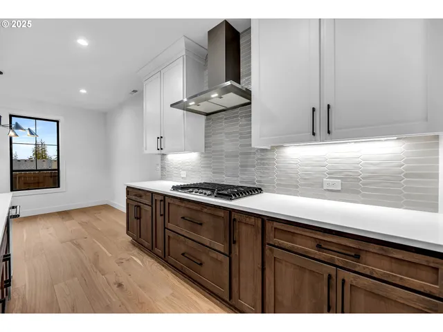 a kitchen with stainless steel appliances a stove microwave and cabinets