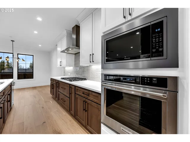 a kitchen with granite countertop a sink stove and cabinets