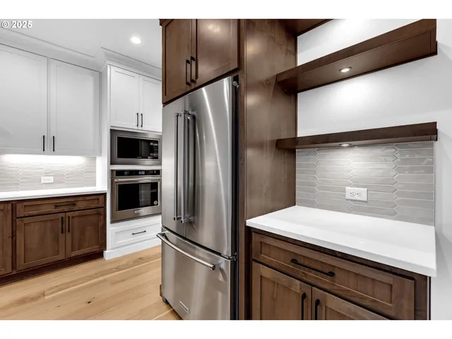 a kitchen with a sink appliances and cabinets