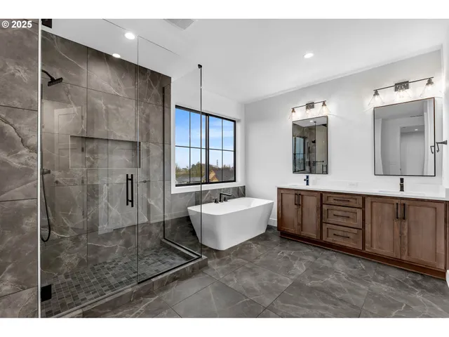 a bathroom with a double vanity sink a mirror and window