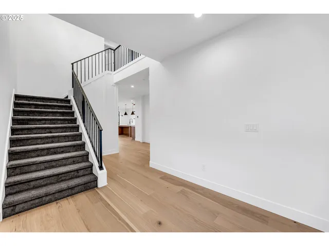 a view of an entryway with wooden floor