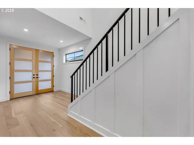 a view of an empty room with a fireplace and a large window