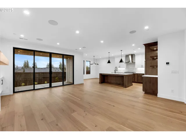 a view of an empty room with a fireplace and a window