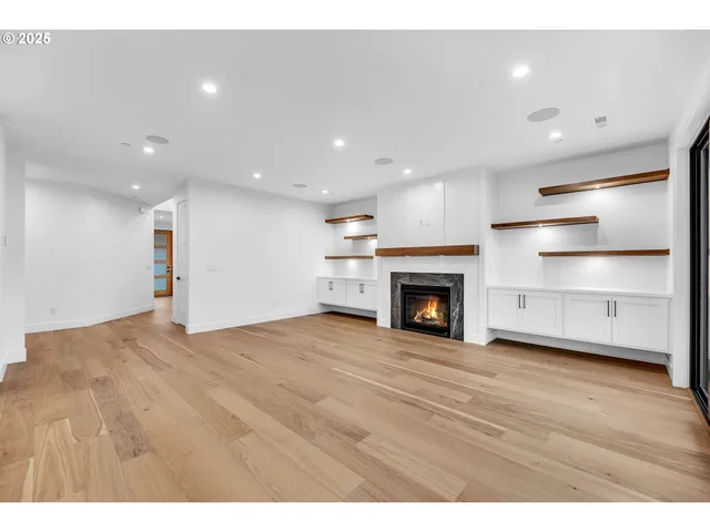 a view of kitchen with cabinets and fireplace