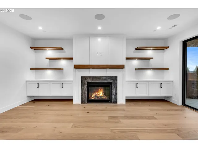 a kitchen with stainless steel appliances granite countertop a sink a stove and a refrigerator