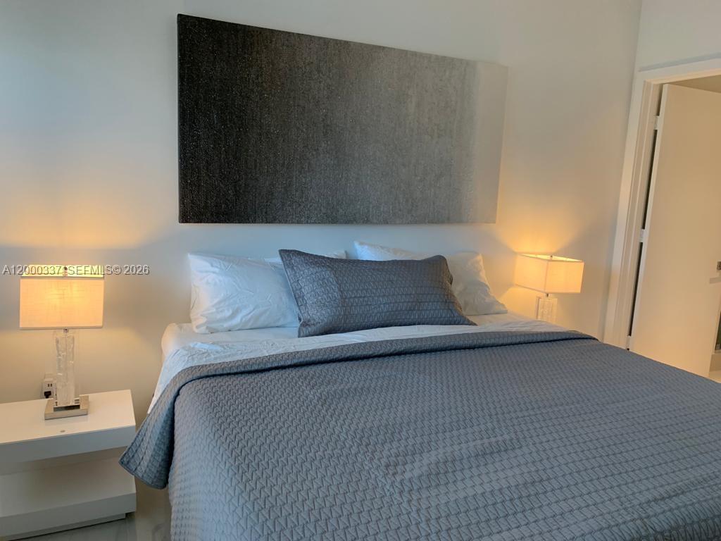 650 Northeast 32nd Street, Unit 705 Miami, FL 33137 - Photo 11 of 24 a bedroom with a bed and a window
