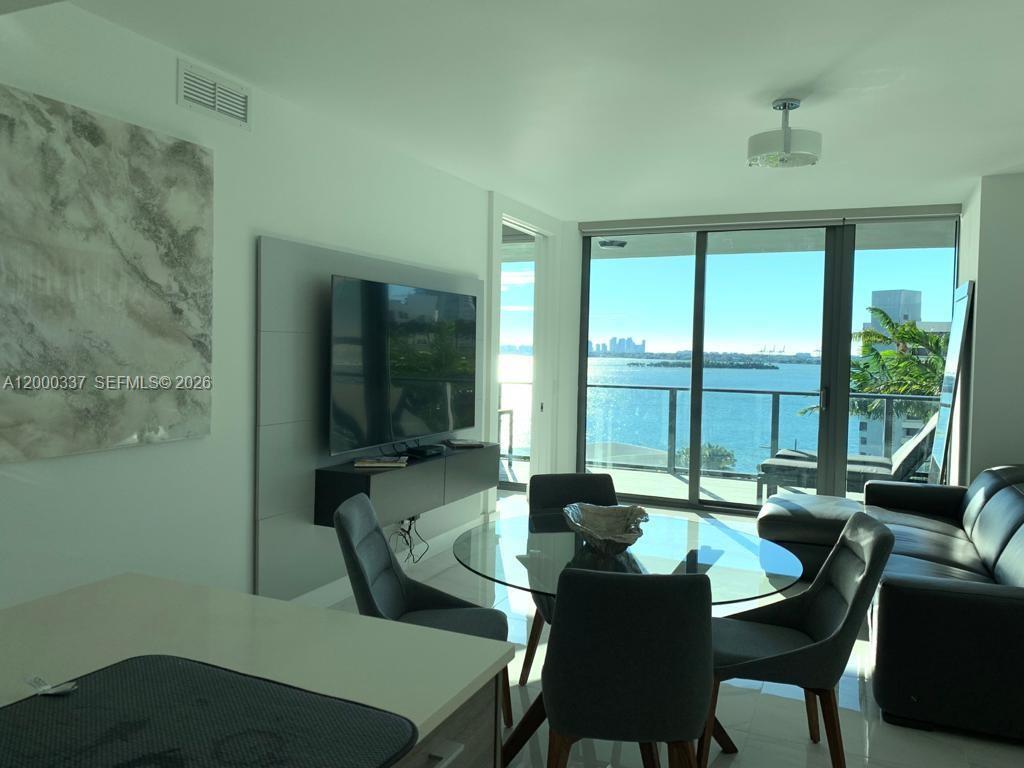 650 Northeast 32nd Street, Unit 705 Miami, FL 33137 - Photo 14 of 24 a view of a dining room with furniture window and outside view