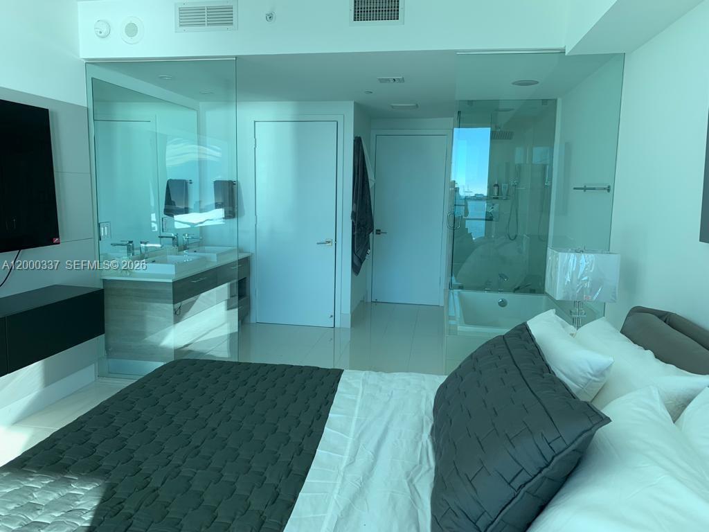 650 Northeast 32nd Street, Unit 705 Miami, FL 33137 - Photo 16 of 24 a spacious bathroom with a double vanity sink and a mirror