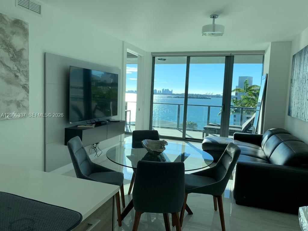 650 Northeast 32nd Street, Unit 705 Miami, FL 33137 - Photo 3 of 24 a dining room with furniture and a large window