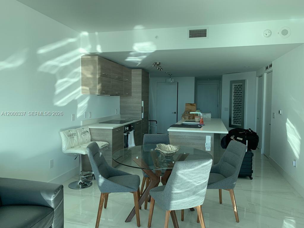 650 Northeast 32nd Street, Unit 705 Miami, FL 33137 - Photo 4 of 24 a workspace with furniture and window
