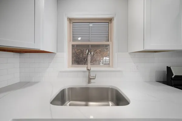 a bathroom with a sink and mirror