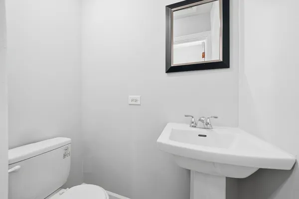 a bathroom with a sink a mirror and toilet