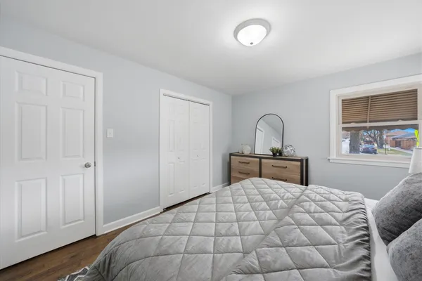 a bedroom with a large bed and a window