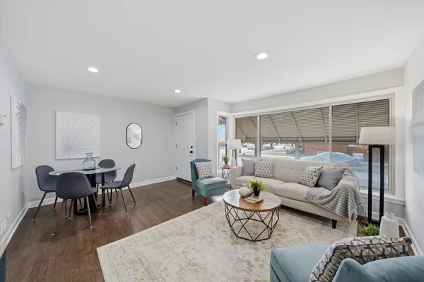 a living room with furniture and wooden floor