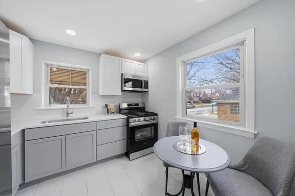 a kitchen with a sink stove and microwave