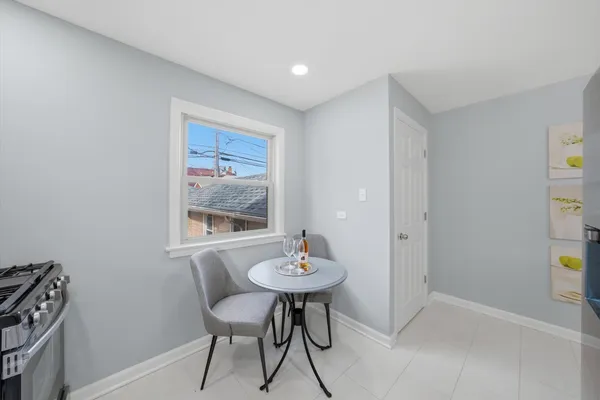a dining room with furniture and a mirror