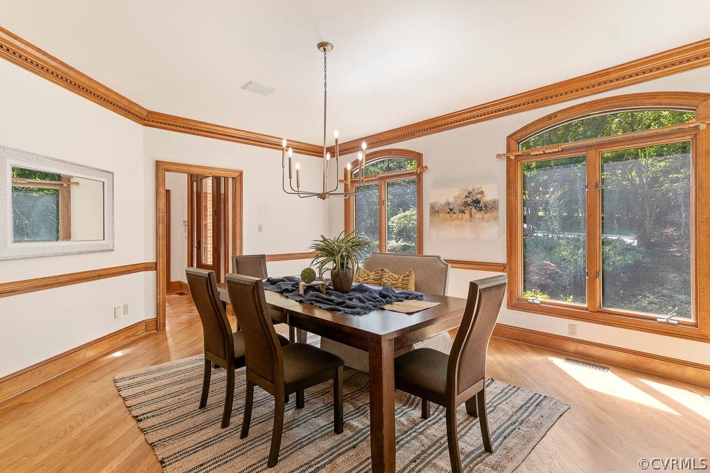 4110 Reeds Landing Circle Midlothian, VA 23113 - Photo 7 of 50 a dining room with furniture a chandelier and wooden floor