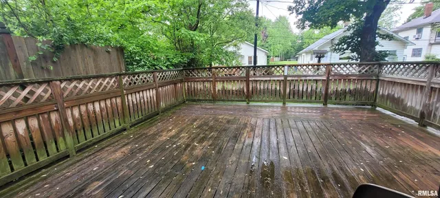 a view of deck with wooden floor and fence and trees