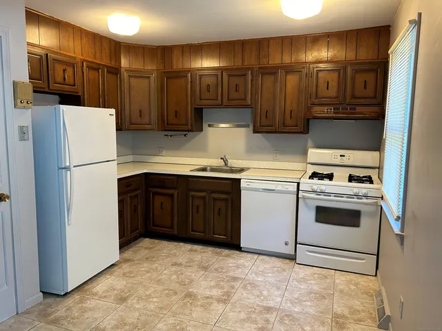 a kitchen with stainless steel appliances a refrigerator and a stove top oven