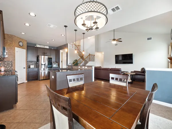 a room with table chairs and a chandelier