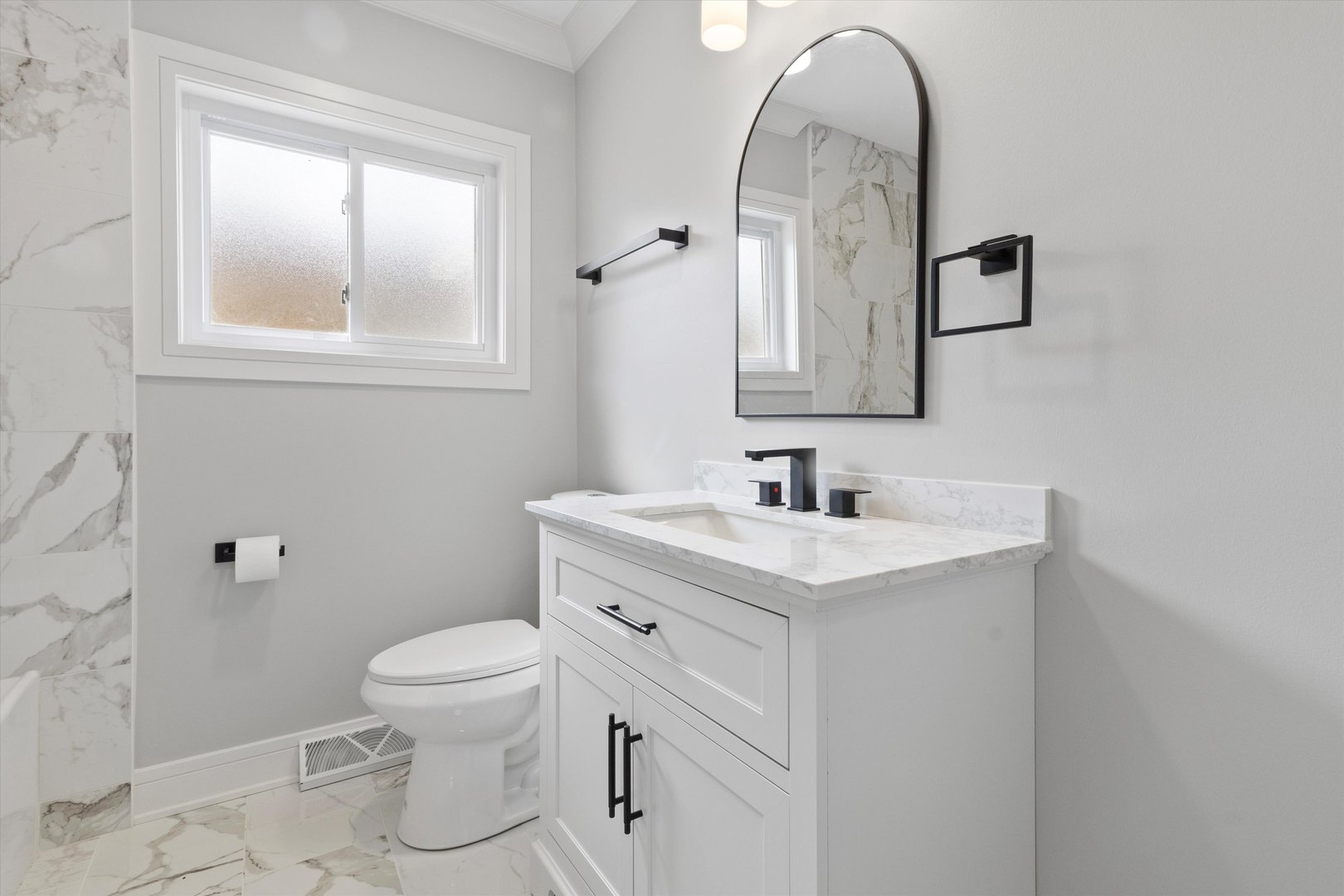 8804 South Fairfield Avenue Evergreen Park, IL 60805 - Photo 11 of 38 a bathroom with a toilet sink and mirror