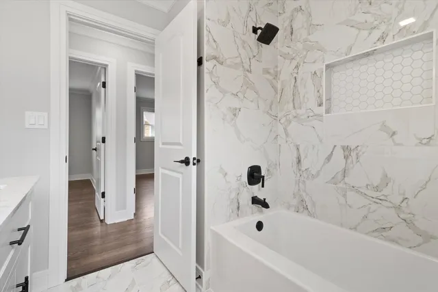 a bathroom with a bathtub and shower