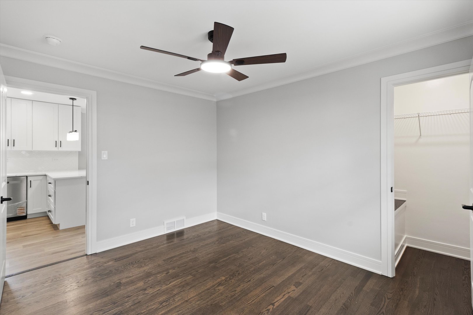 8804 South Fairfield Avenue Evergreen Park, IL 60805 - Photo 13 of 38 an empty room with wooden floor and a ceiling fan