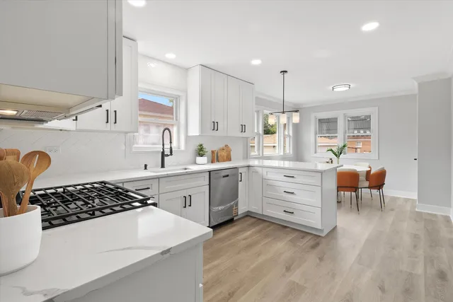 a kitchen with white cabinets and appliances