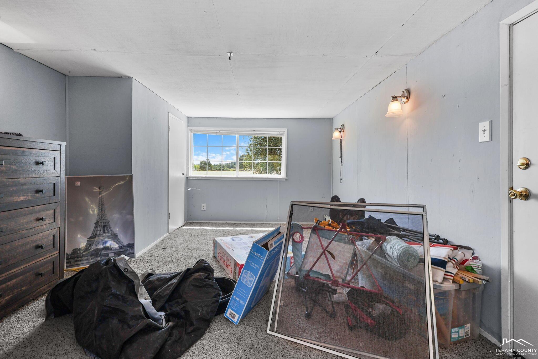 22275 Brent Road Red Bluff, CA 96080 - Photo 40 of 47 a bedroom with a bed and wooden floor