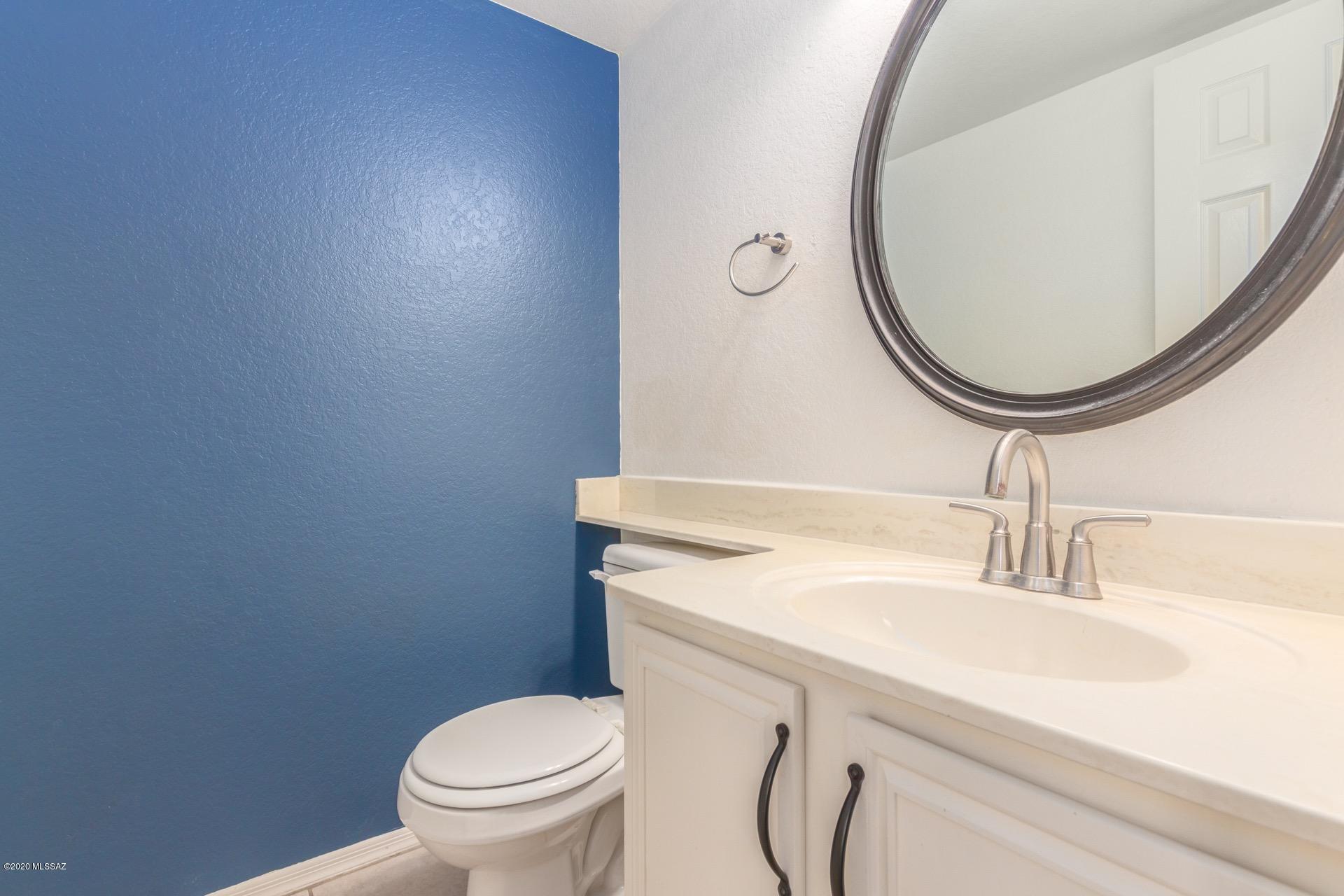 3580 West Sky Ridge Loop Tucson, AZ 85742 - Photo 16 of 29 a bathroom with a sink a toilet and a mirror