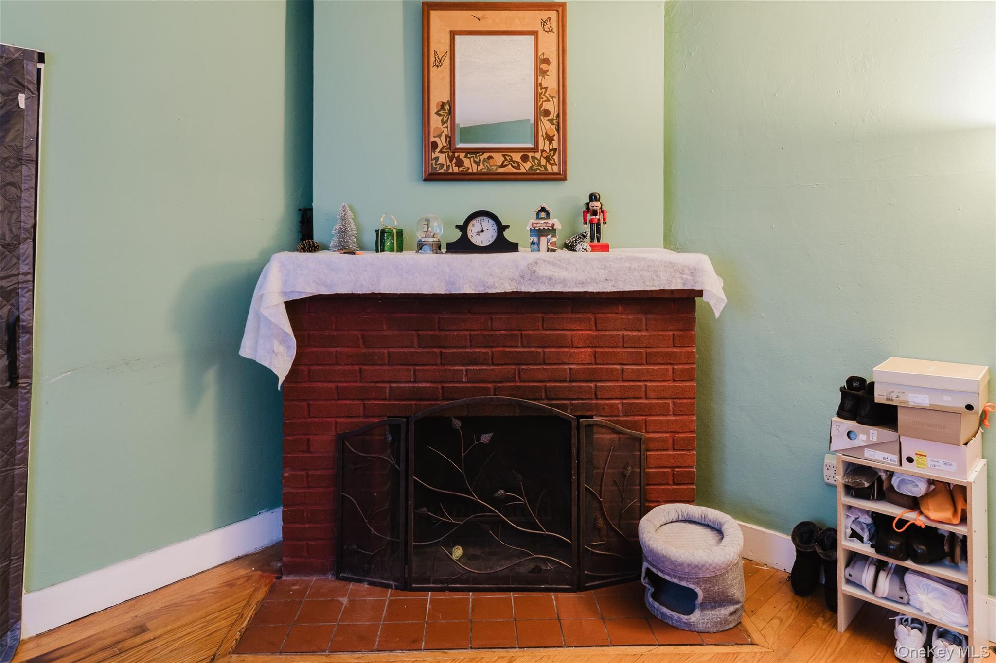 6 Stowe Road Peekskill, NY 10566 - Photo 2 of 17 Detailed view of a brick fireplace and wood finished floors