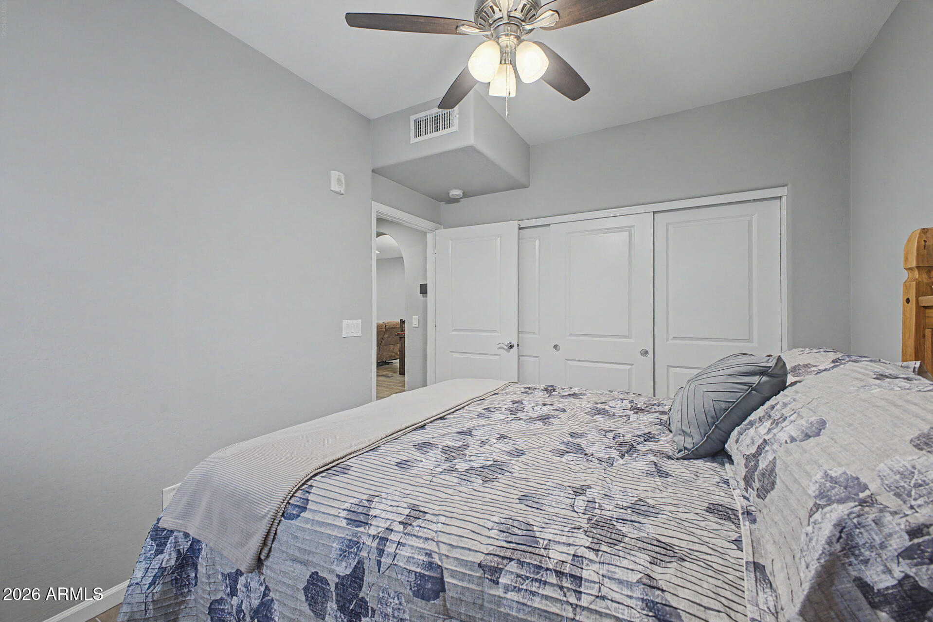 3935 East Rough Rider Road, Unit 1339 Phoenix, AZ 85050 - Photo 14 of 36 a bedroom with a large bed and a chandelier