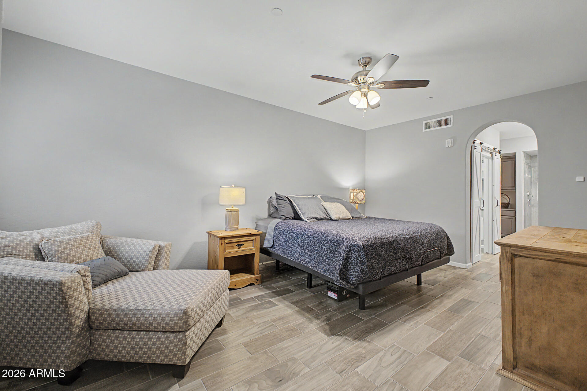 3935 East Rough Rider Road, Unit 1339 Phoenix, AZ 85050 - Photo 17 of 36 a bedroom with a bed couch and a ceiling fan