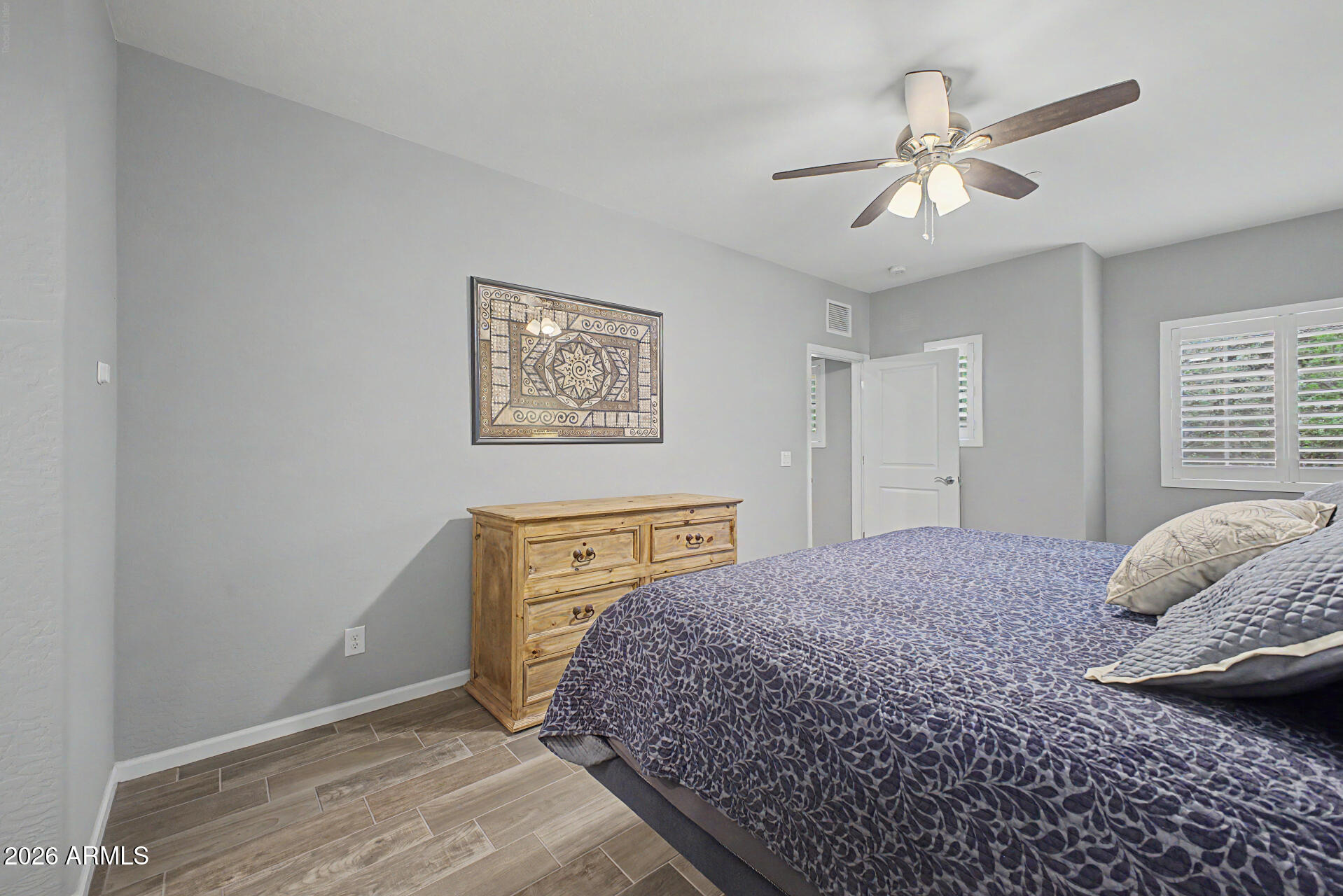 3935 East Rough Rider Road, Unit 1339 Phoenix, AZ 85050 - Photo 19 of 36 a bedroom with a bed and a chandelier