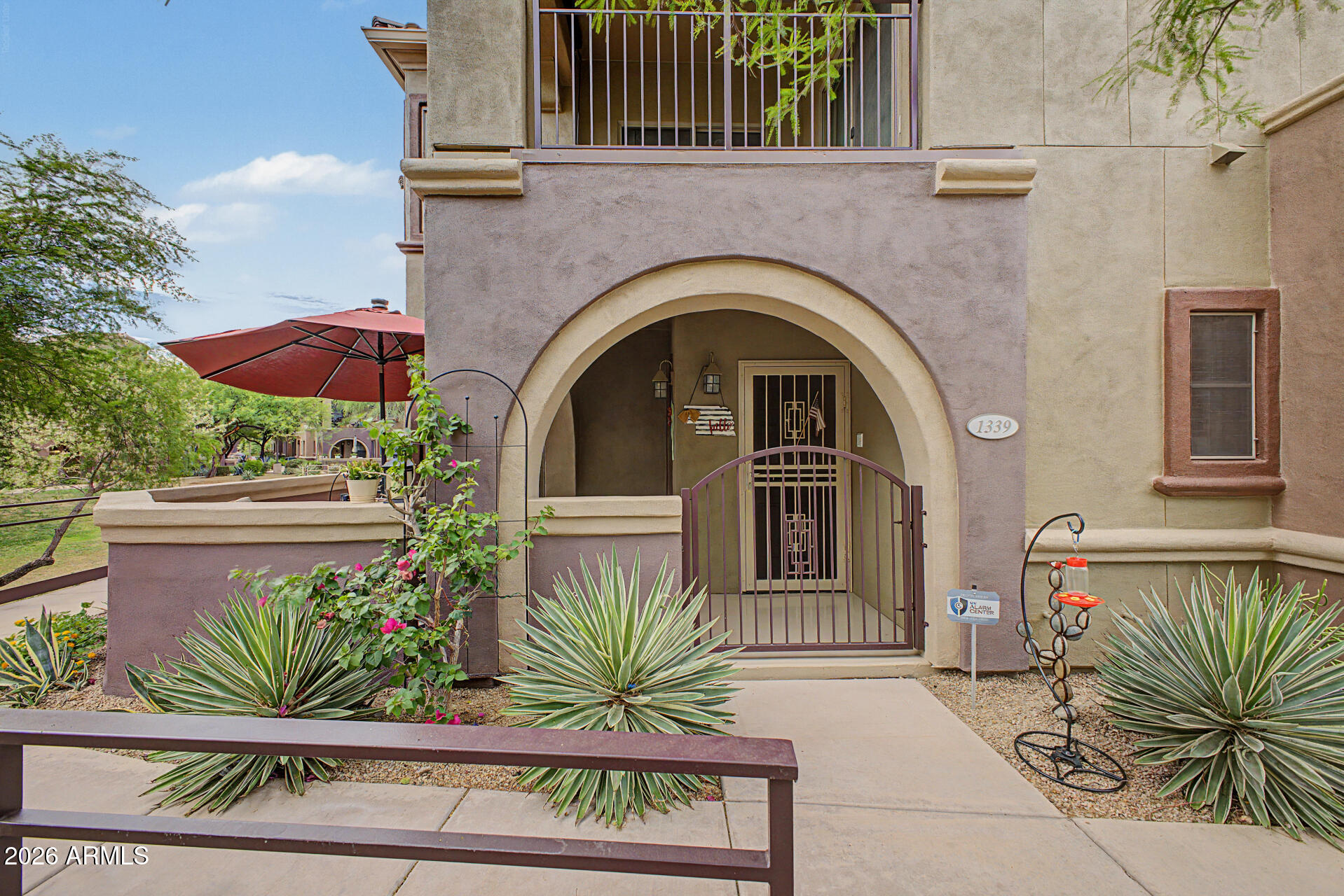 3935 East Rough Rider Road, Unit 1339 Phoenix, AZ 85050 - Photo 28 of 36 a front view of a house with plants