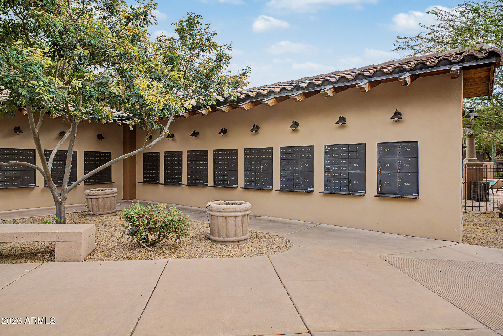 3935 East Rough Rider Road, Unit 1339 Phoenix, AZ 85050 - Photo 29 of 36 a front view of a house with a garden