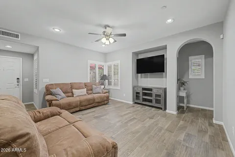 a bedroom with a large bed and a chandelier
