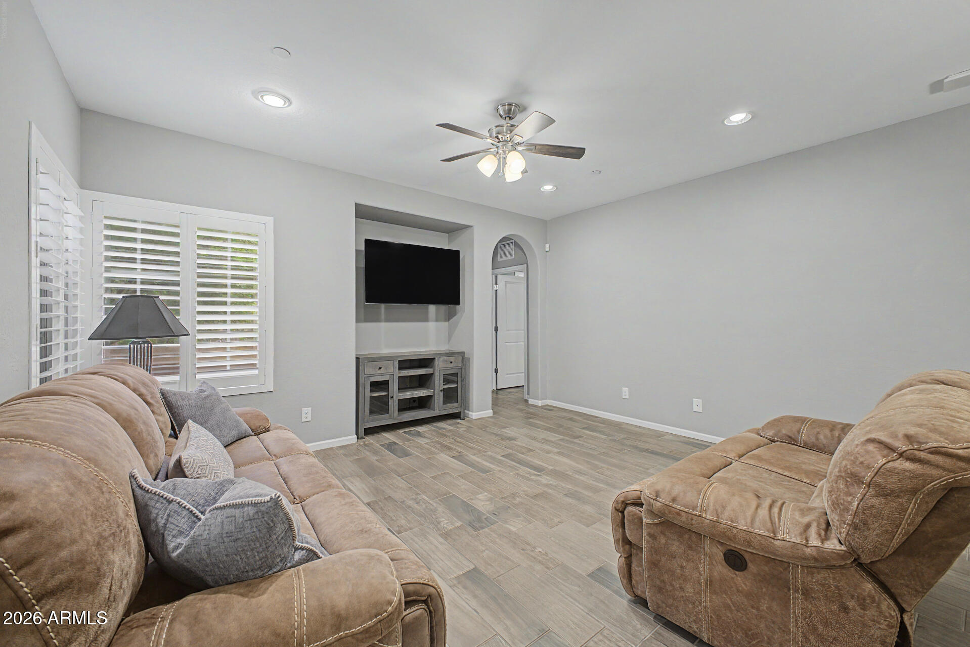 3935 East Rough Rider Road, Unit 1339 Phoenix, AZ 85050 - Photo 8 of 36 a living room with furniture and a flat screen tv with kitchen view