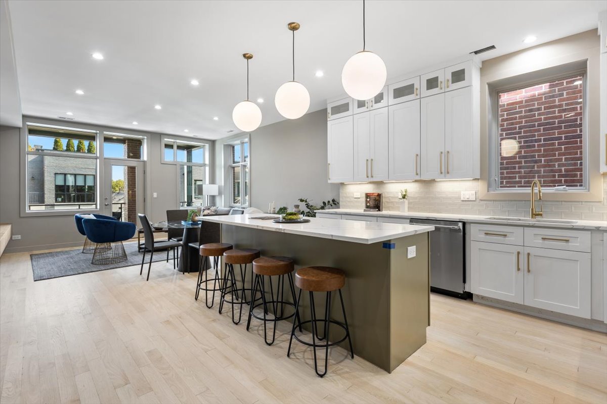 2448 North Clybourn Avenue, Unit 4 Chicago, IL 60614 - Photo 11 of 24 a large kitchen with granite countertop a stove a sink a dining table and chairs