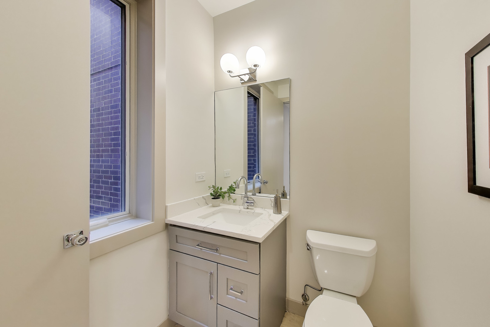 2448 North Clybourn Avenue, Unit 4 Chicago, IL 60614 - Photo 12 of 24 a bathroom with a toilet sink and mirror