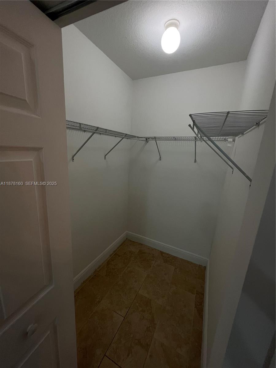 211 West 79th Place, Unit 302 Hialeah, FL 33014 - Photo 12 of 16 a view of a room with racks on the wall