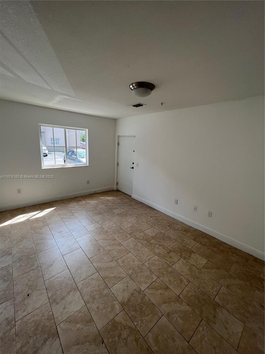 211 West 79th Place, Unit 302 Hialeah, FL 33014 - Photo 3 of 16 an empty room with a empty space and window