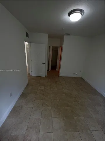 an empty room with a empty space and windows