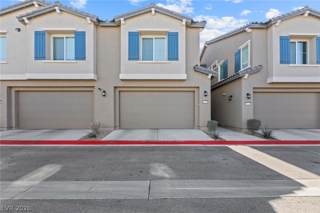 7310 North Decatur Boulevard, Unit 4 North Las Vegas, NV 89084 - Photo 1 of 35 Attached garages and blue decorative shutters define the welcoming facade of these townhomes.