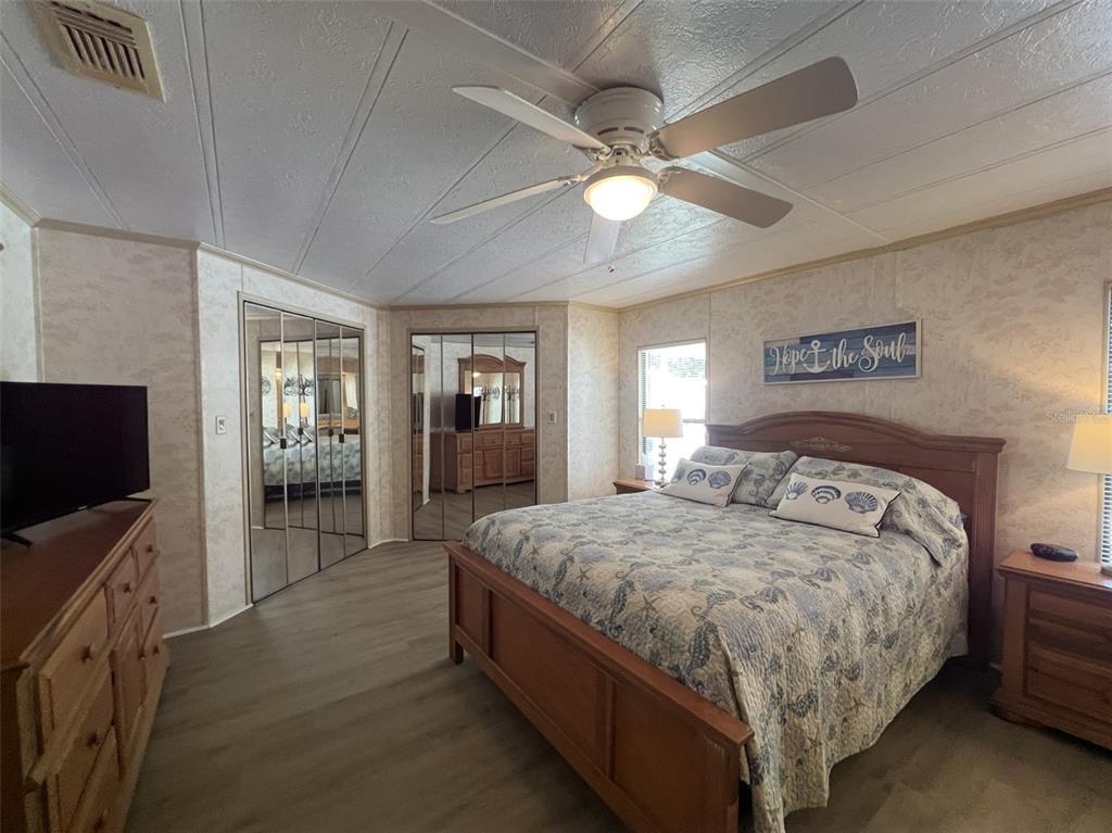 2055 South Floral Avenue, Unit 133 Bartow, FL 33830 - Photo 27 of 62 a bedroom with bed and flat tv screen on dresser