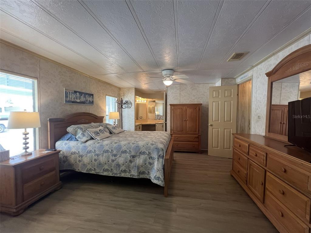 2055 South Floral Avenue, Unit 133 Bartow, FL 33830 - Photo 29 of 62 a spacious bedroom with a bed and a flat screen tv