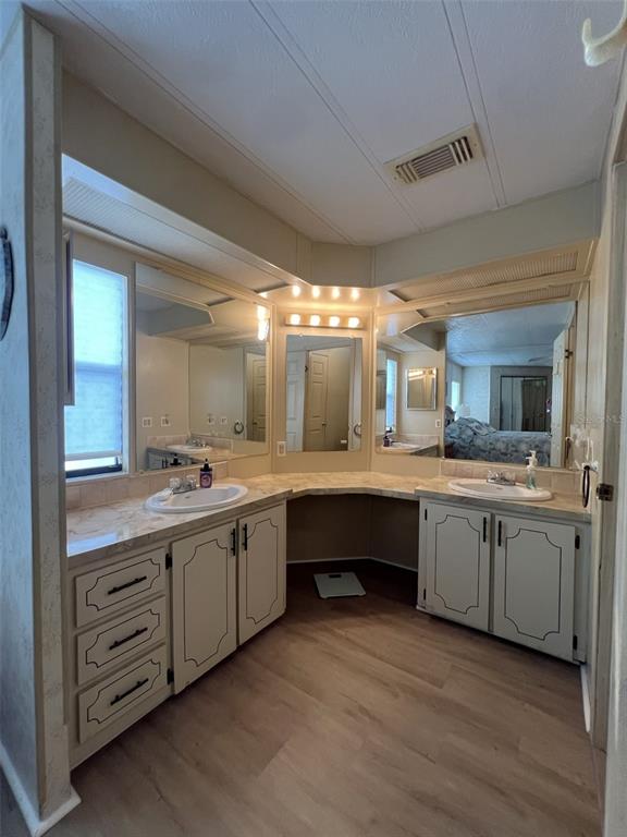 2055 South Floral Avenue, Unit 133 Bartow, FL 33830 - Photo 32 of 62 a large bathroom with a double vanity sink and a mirror
