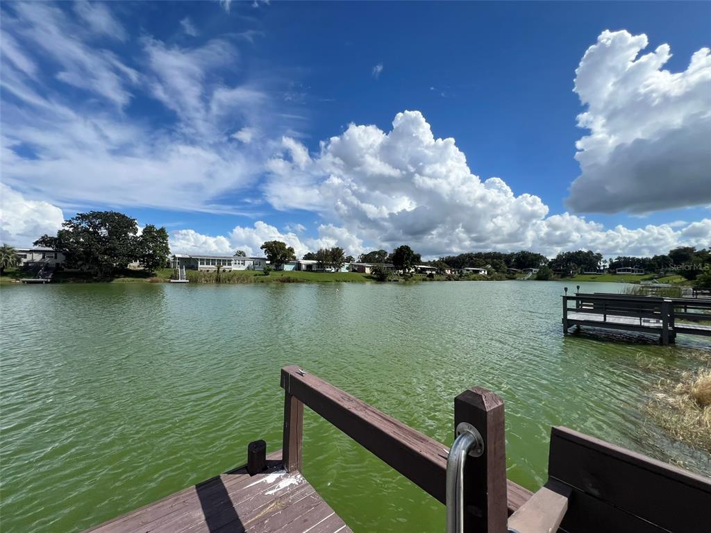 2055 South Floral Avenue, Unit 133 Bartow, FL 33830 - Photo 54 of 62 a view of a lake with lawn chairs