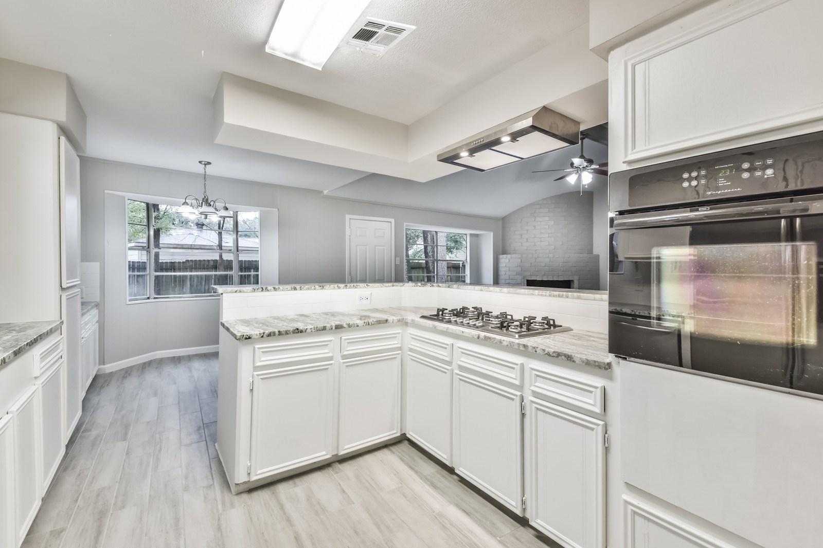 9718 John Bank Drive Spring, TX 77379 - Photo 12 of 39 a kitchen with a sink and refrigerator