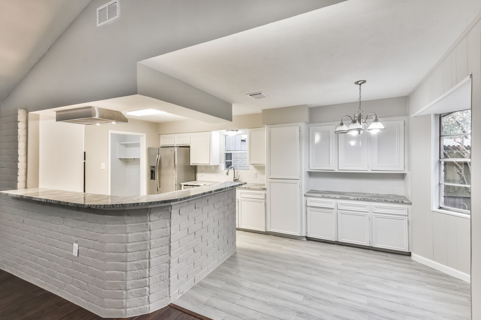 9718 John Bank Drive Spring, TX 77379 - Photo 15 of 39 a kitchen with kitchen island stainless steel appliances a sink and cabinets